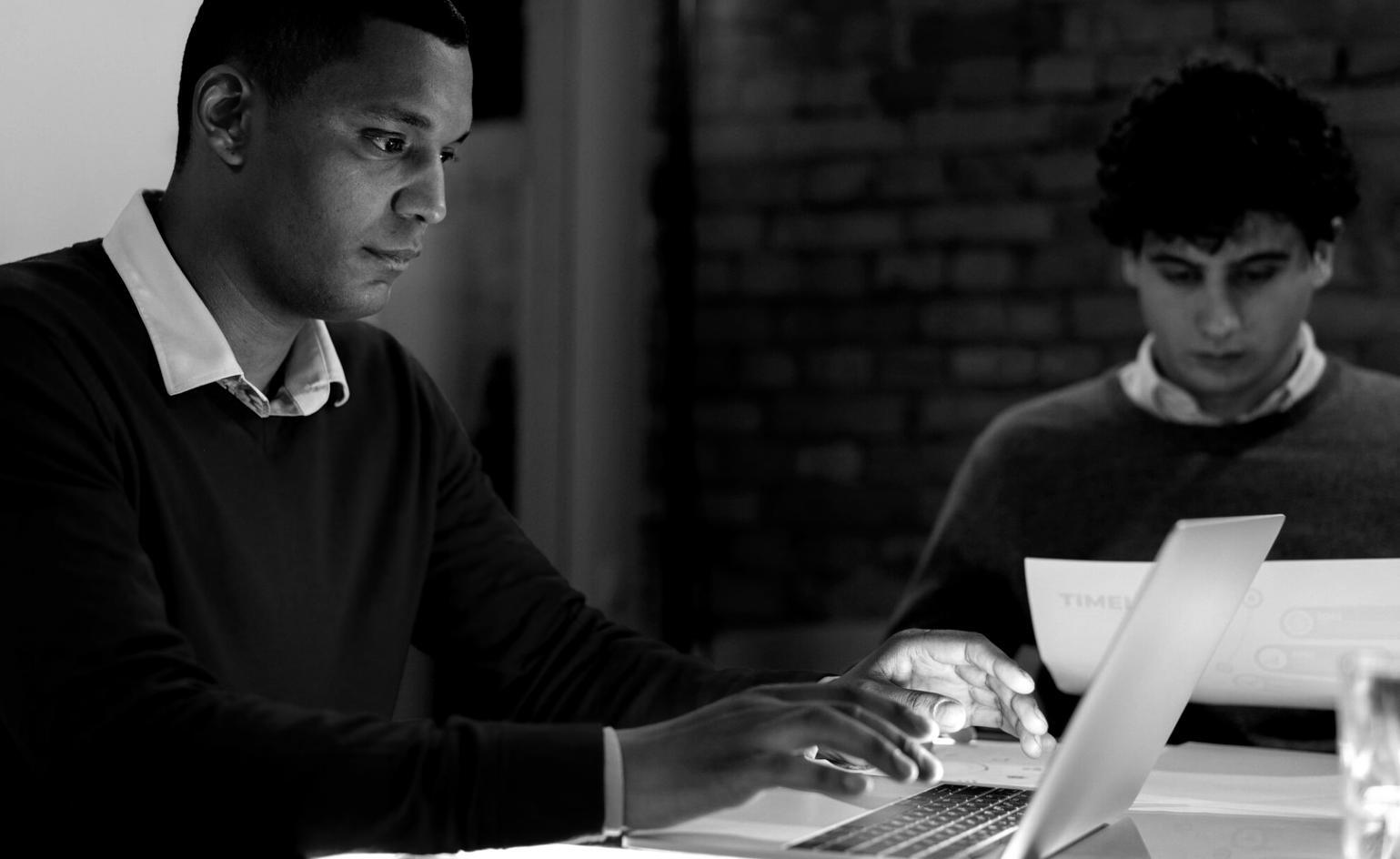 Students collaborating on web interface design projects in a modern learning environment